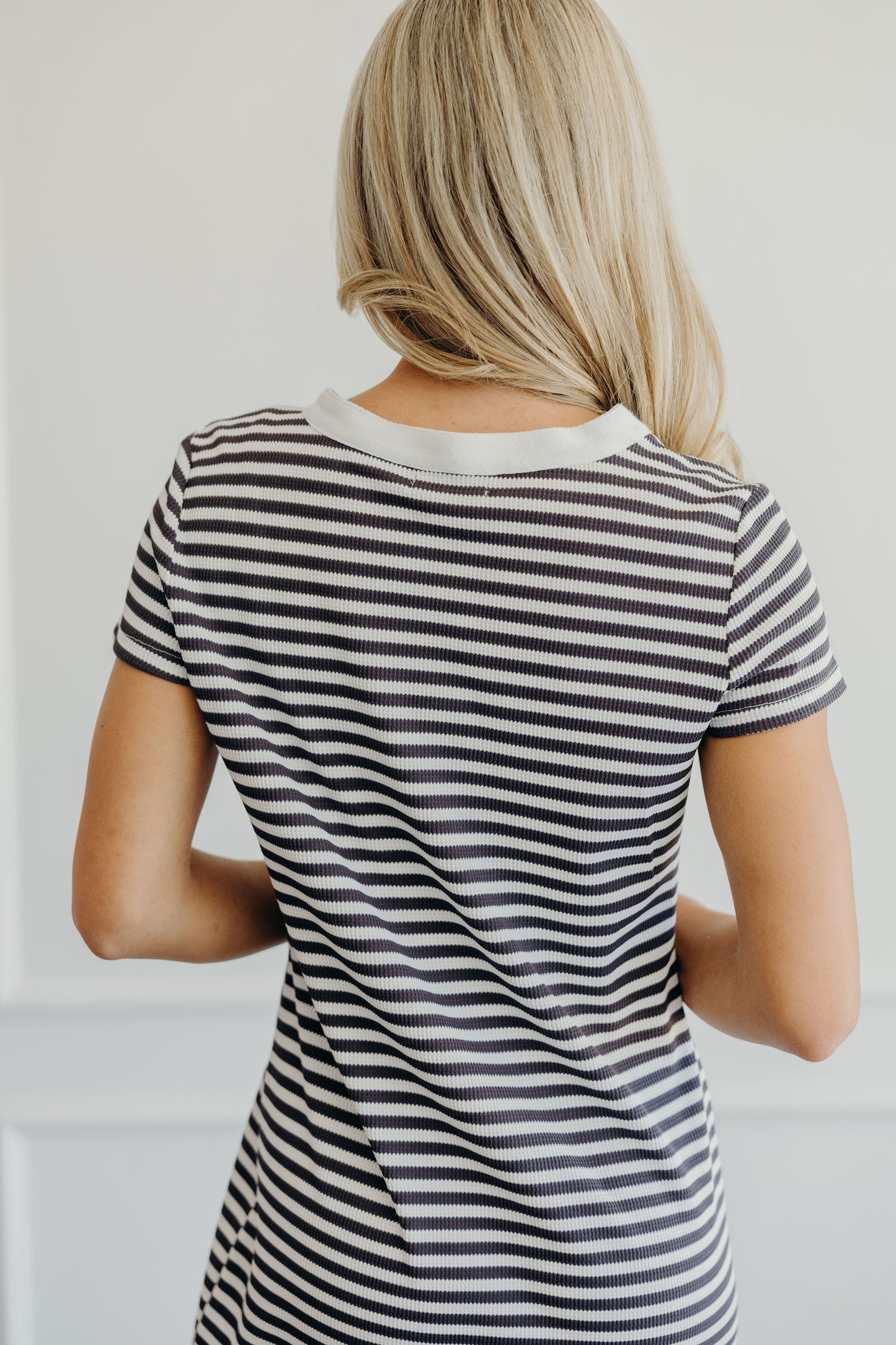 Back of dress with round neckline, short sleeve and striped print.