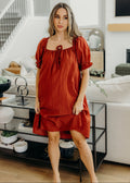 Knee length dress with square neckline and short sleeves.